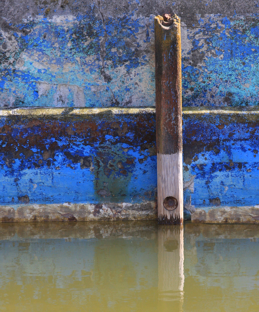 Blue Wall, dirty water and rotting pole