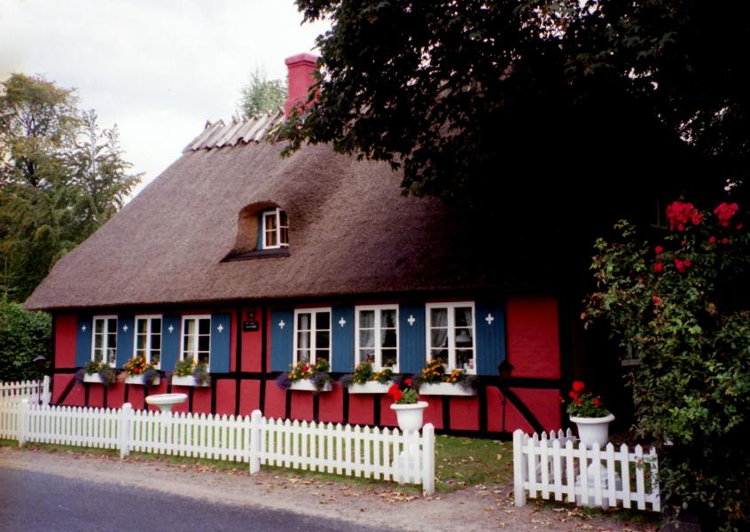 Thatched home on a country road on the island of Fuen, Denmark.