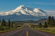 Caution- Volcano Ahead. Mt Shasta is the 5th highest peak in California. It rises abruptly to 14,179 ft. Most prominently seen are the main summit and the satellite cone known as Shastina.