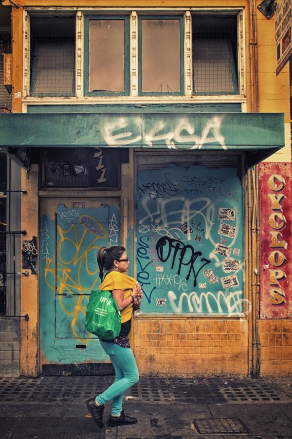 Woman blending with the colors of the Mission District, San Francisco.