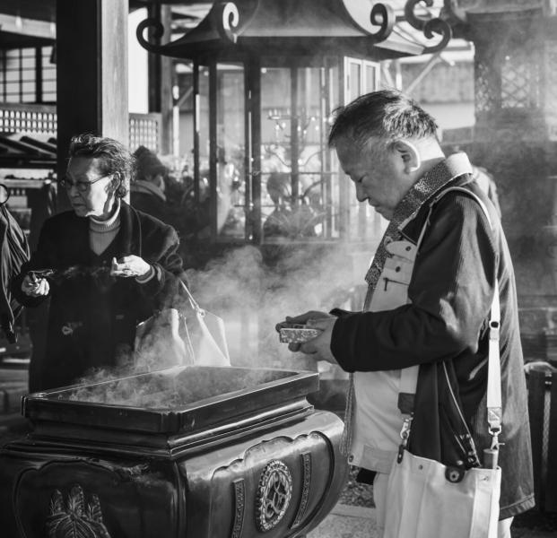 Man Preparing Incense Offering At Temple On New Year's Day, Kyoto