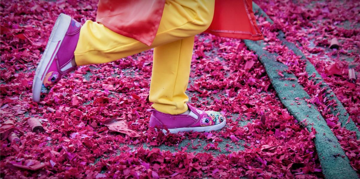 Running on red firecracker paper - Tet New Years Festival.