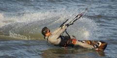 Kitesurfer pulls against kite